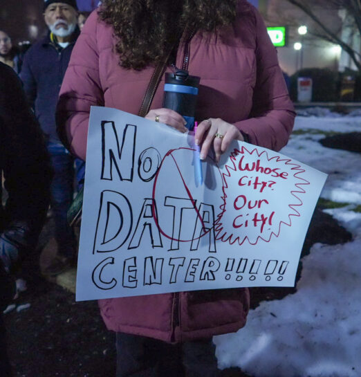 A protester holds a No Data Center sign.