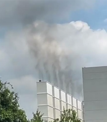Smoke rises above a data center building.