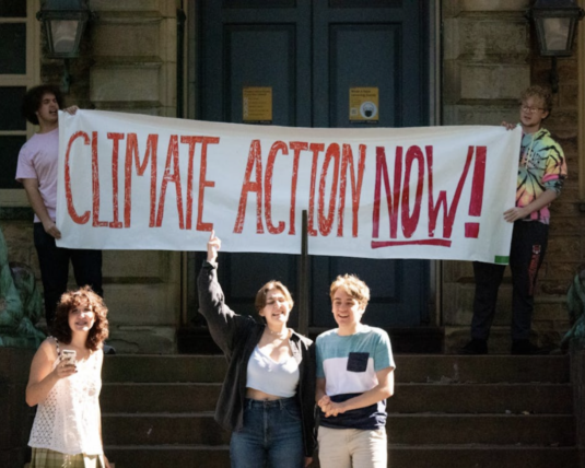 Climate Action Now Young activists in front of a protest sign that says
